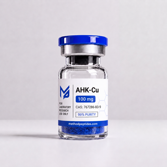 A small glass vial with a blue cap and a white label reading AHK-Cu 100 mg, photographed on a clean light gray background. The label also shows Method Peptides branding and blue powder visible at the bottom of the vial.